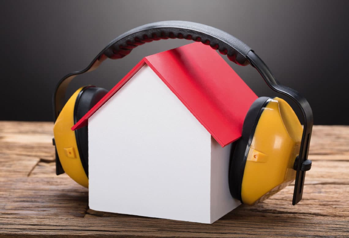 Headphones covering a miniature house