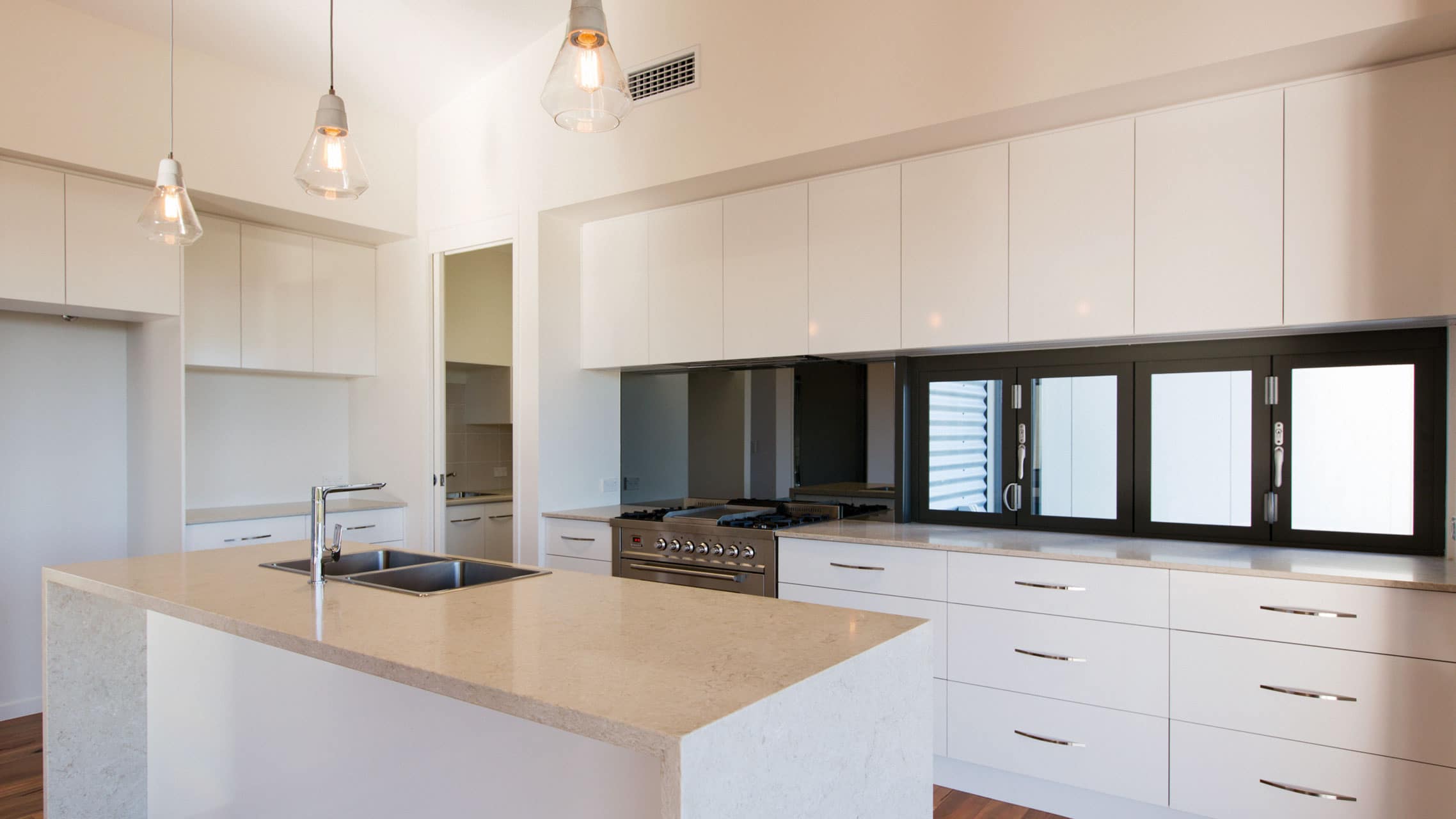 Woodland Grey Aluminium Bi fold Windows above a kitchen bench