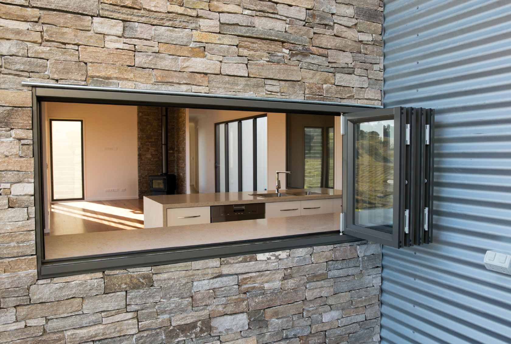 Woodland Grey Aluminium Bi fold Windows used as a servery window