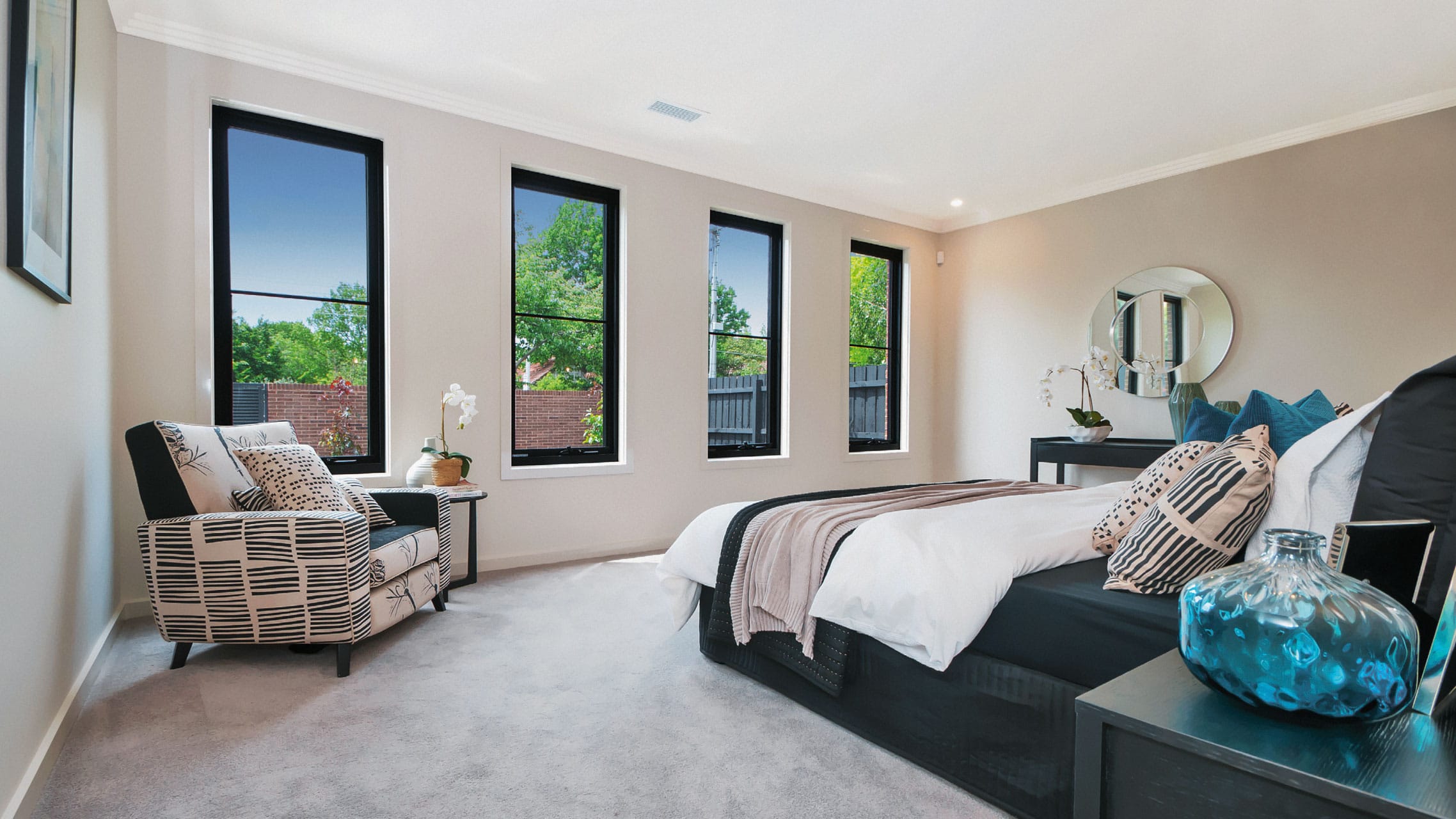 Aluminium Awning Windows with black frames in a bedroom