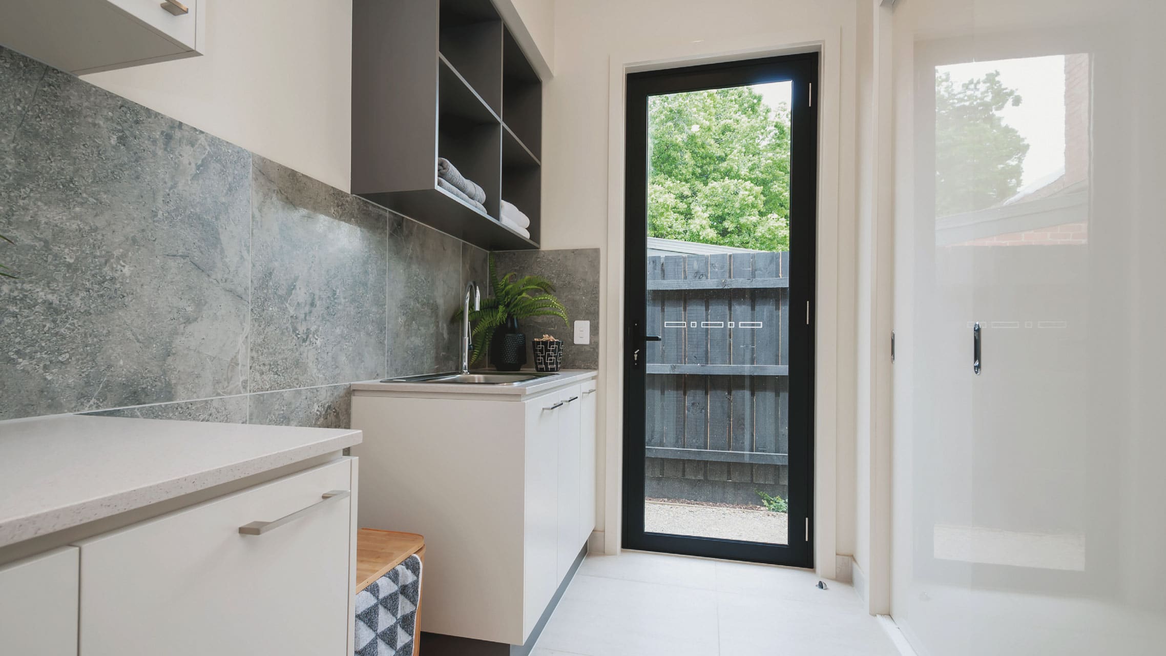 Aluminium Hinged Door with black frame in a laundry room