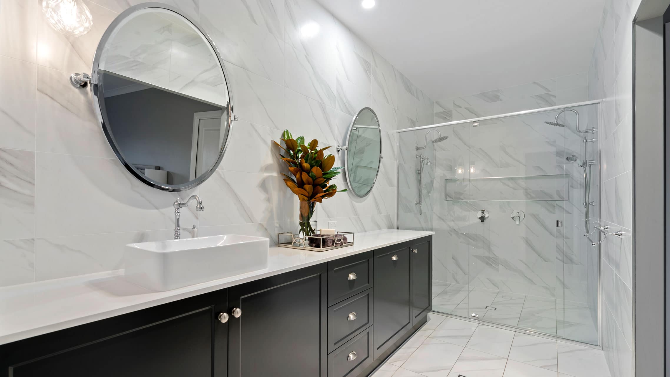 Bathroom with semi frameless shower screen and two round mirrors