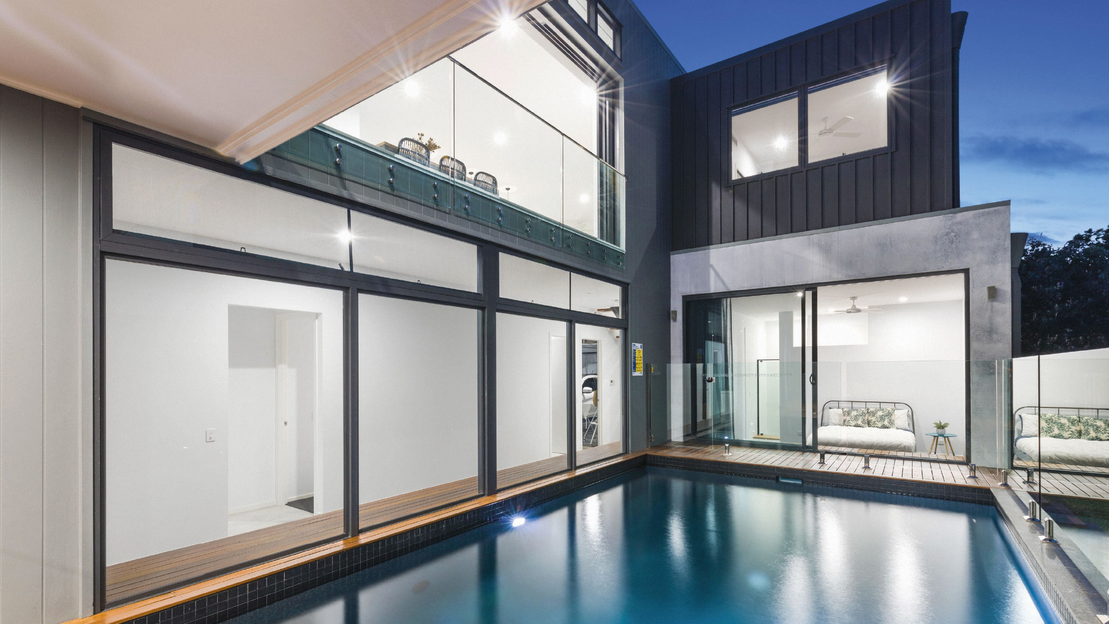 Multiple large fixed windows and sliding doors in a beachfront home