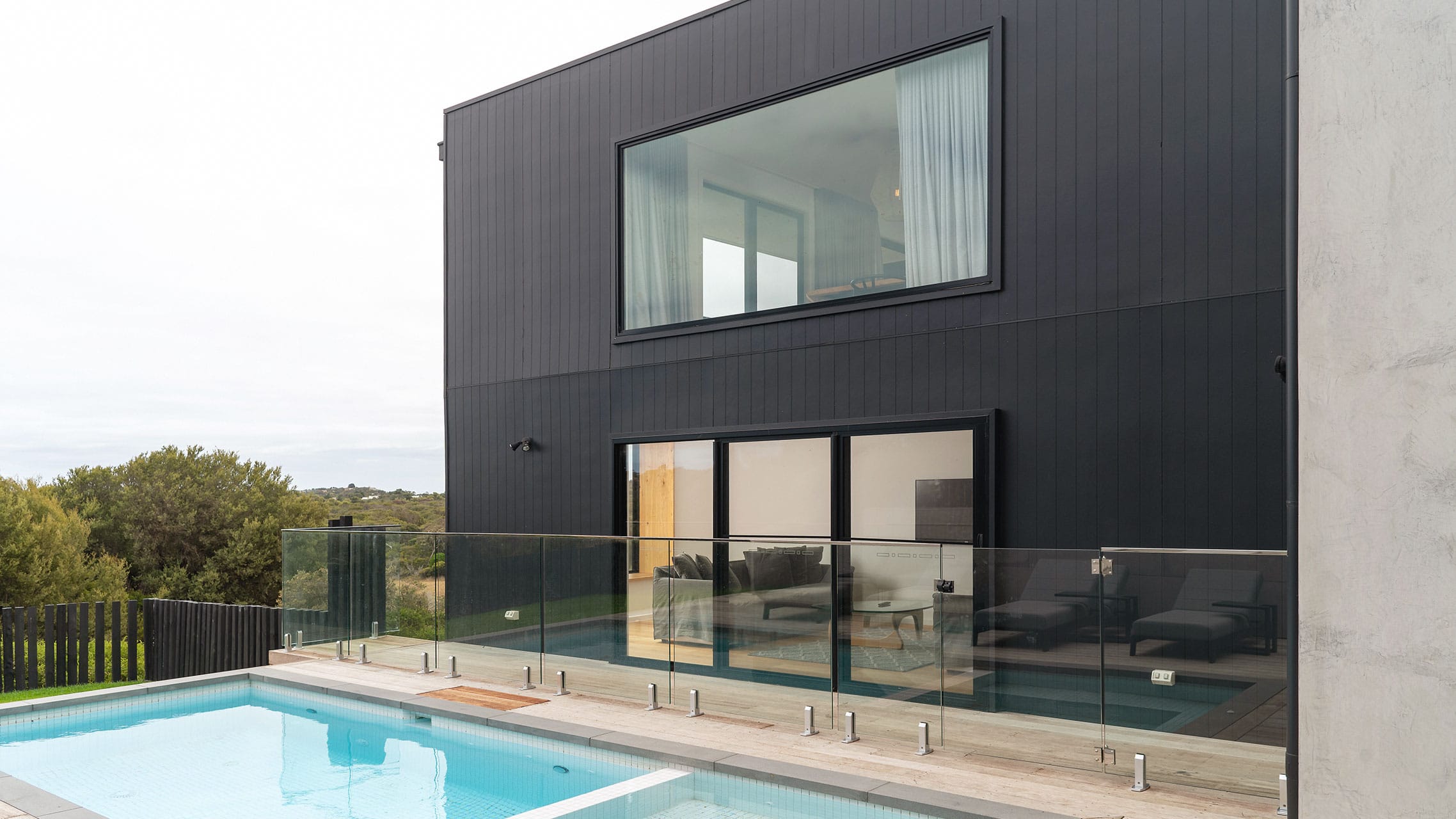Multiple Black Aluminium Windows and Doors in a coastal home