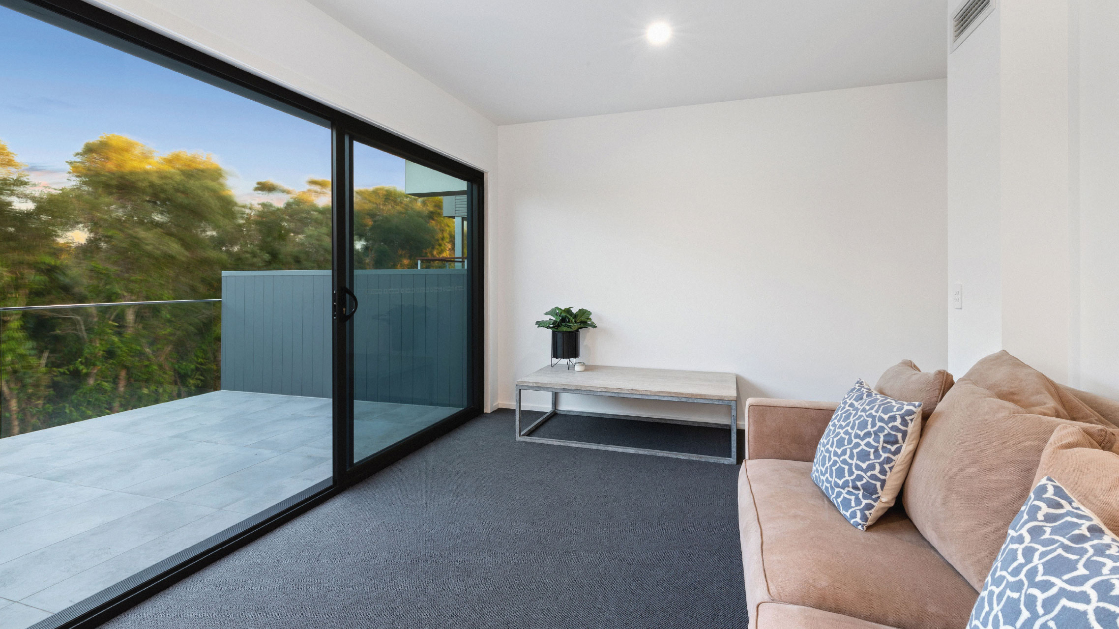 Black Glass Sliding Door opening to a balcony