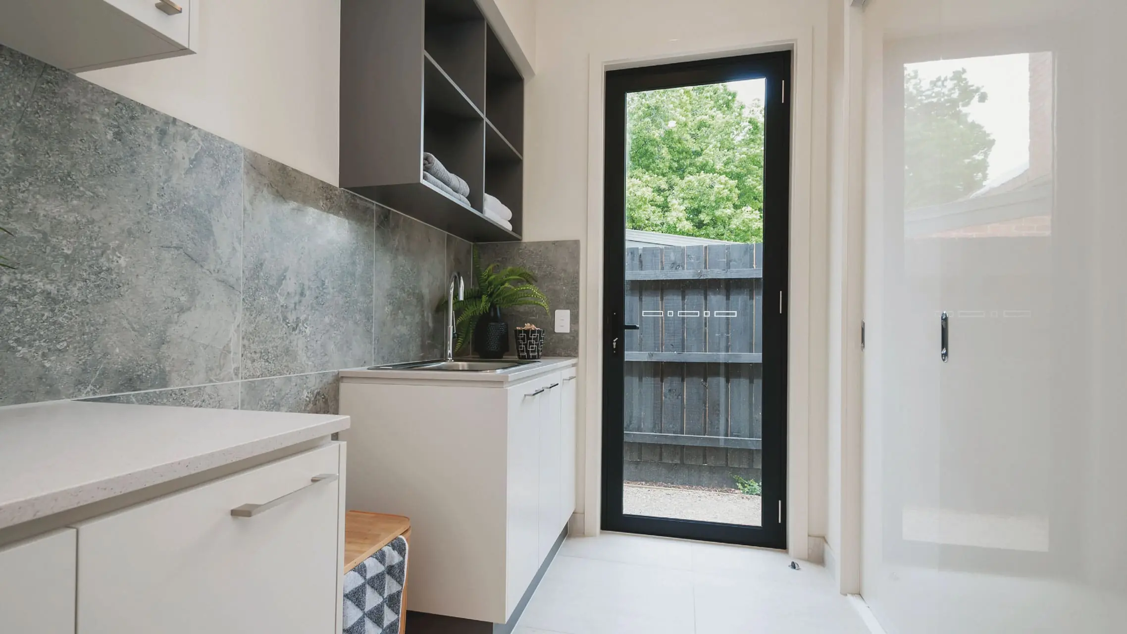Aluminium Hinged Door with black frame in a laundry room