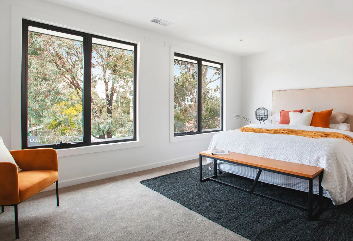 Two hybrid awning windows in bedroom